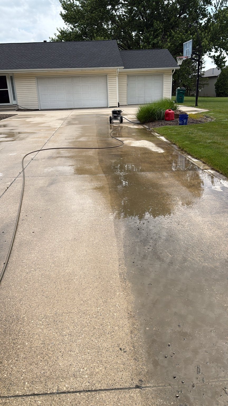 Driveway pressure washing in progress